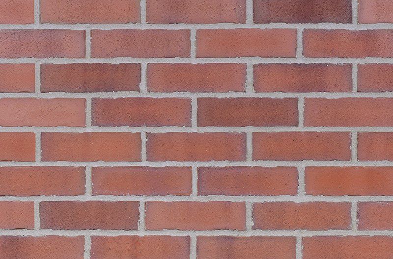 Red brick wall with white mortar.