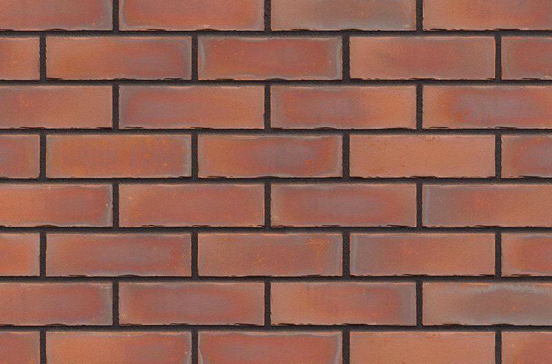 Red brick wall with dark gray mortar.