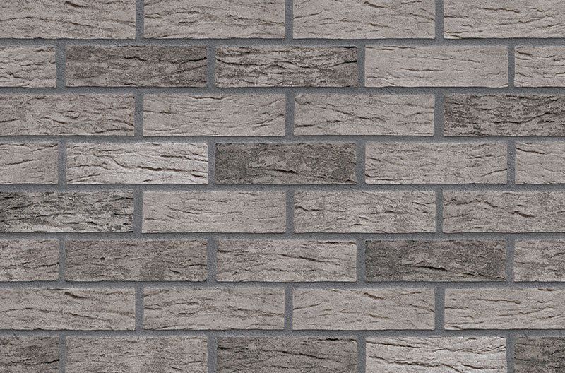 Gray brick wall with varying shades and textured surface.