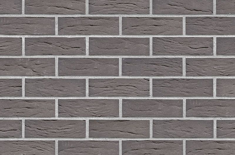 Dark gray brick wall with light gray mortar.