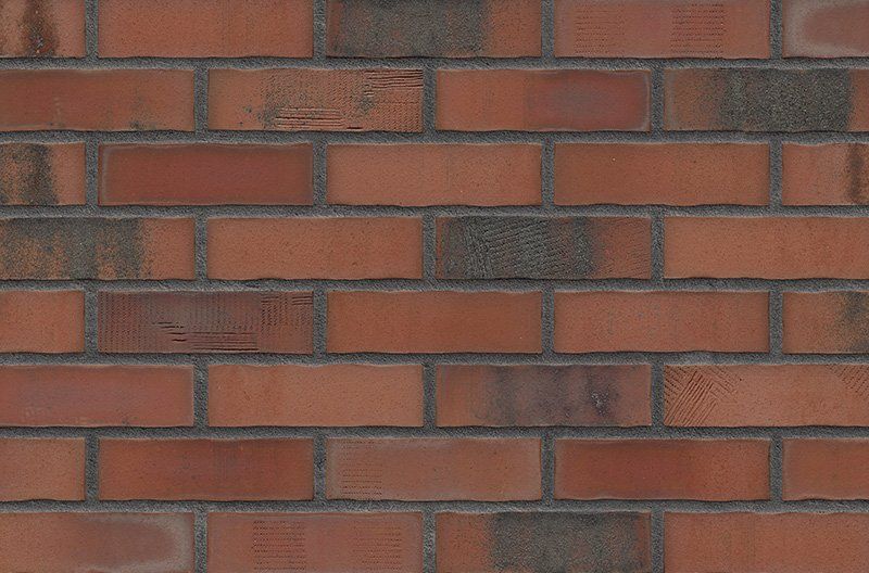 Red brick wall with dark mortar.