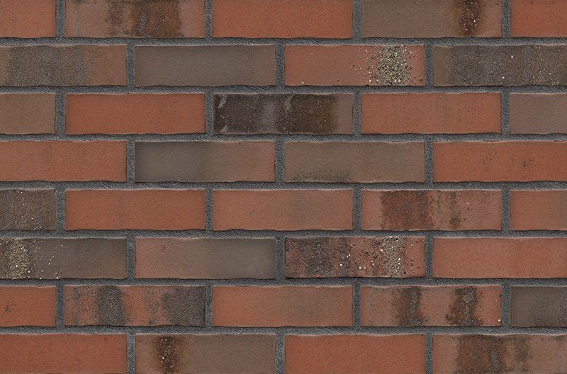 Brick wall, red-brown bricks with dark mortar.