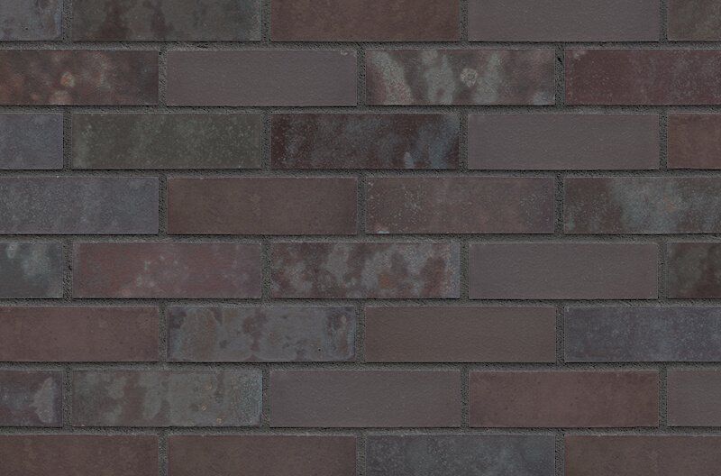 Brick wall, multi-toned browns and grays in a repeating pattern.
