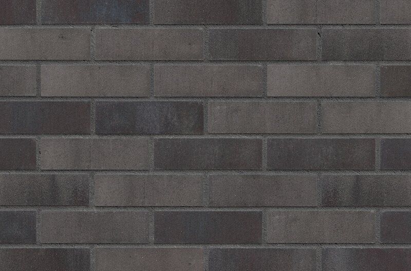 Dark gray brick wall with varying shades and textures.