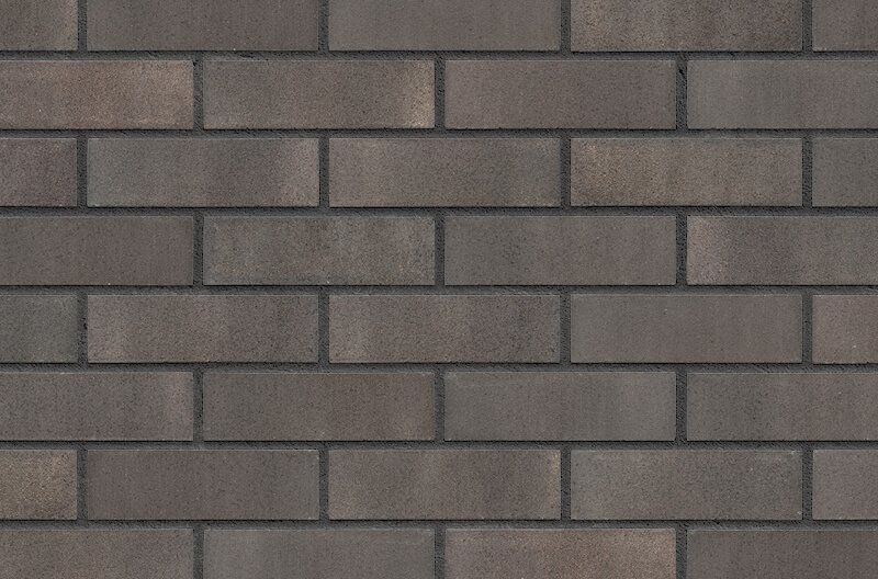 Dark gray brick wall with rectangular blocks and dark mortar.