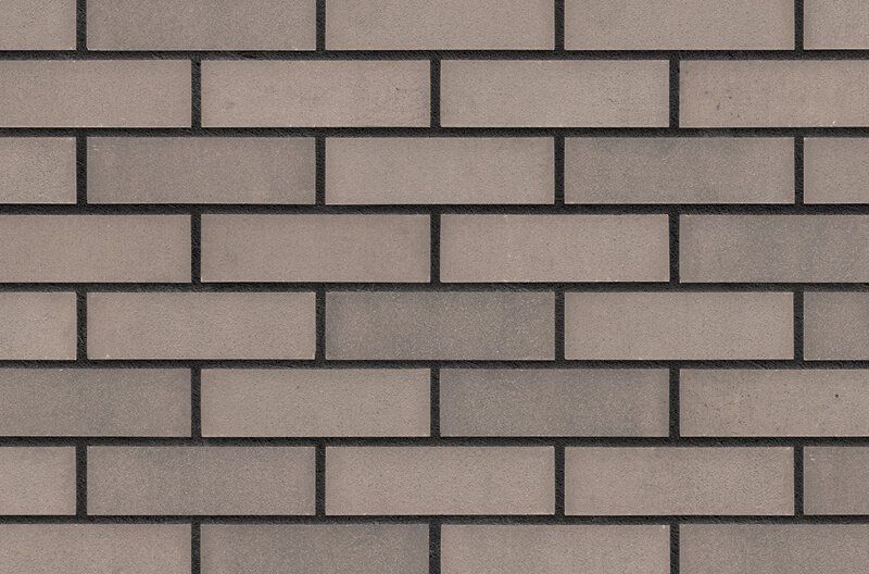 Light and dark gray brick wall with dark mortar.
