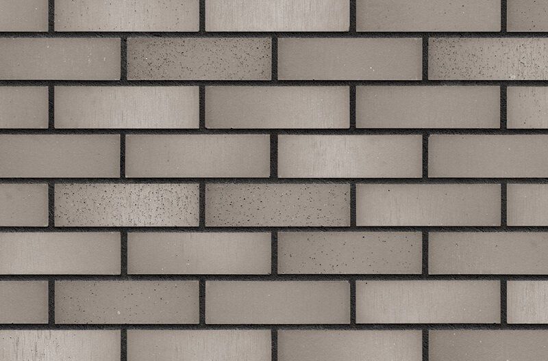 Tan brick wall with dark gray grout.