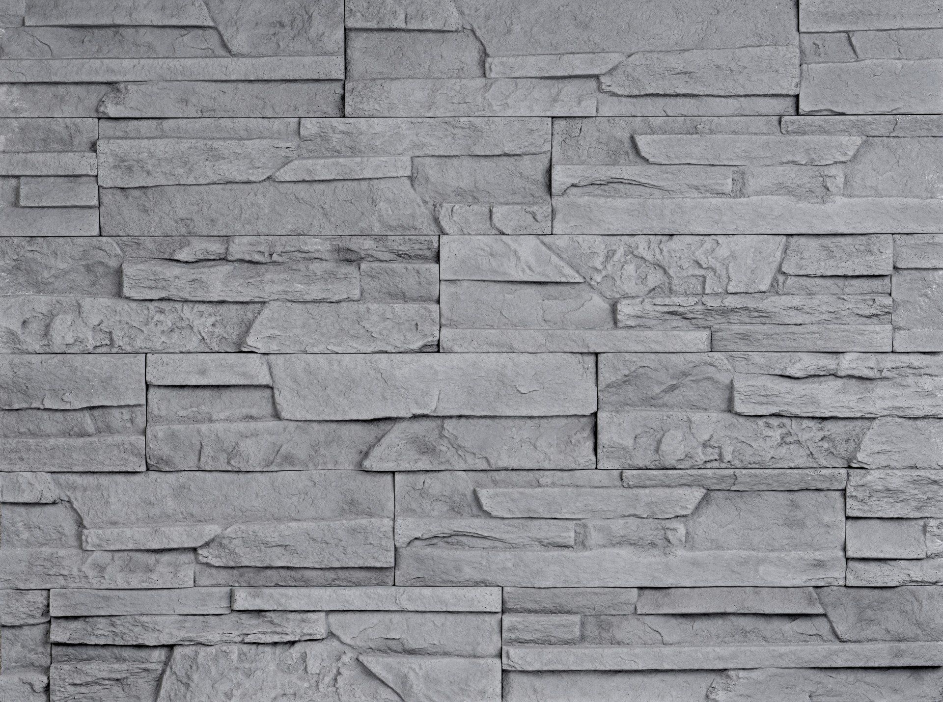 Gray stone wall made of rectangular, layered blocks.