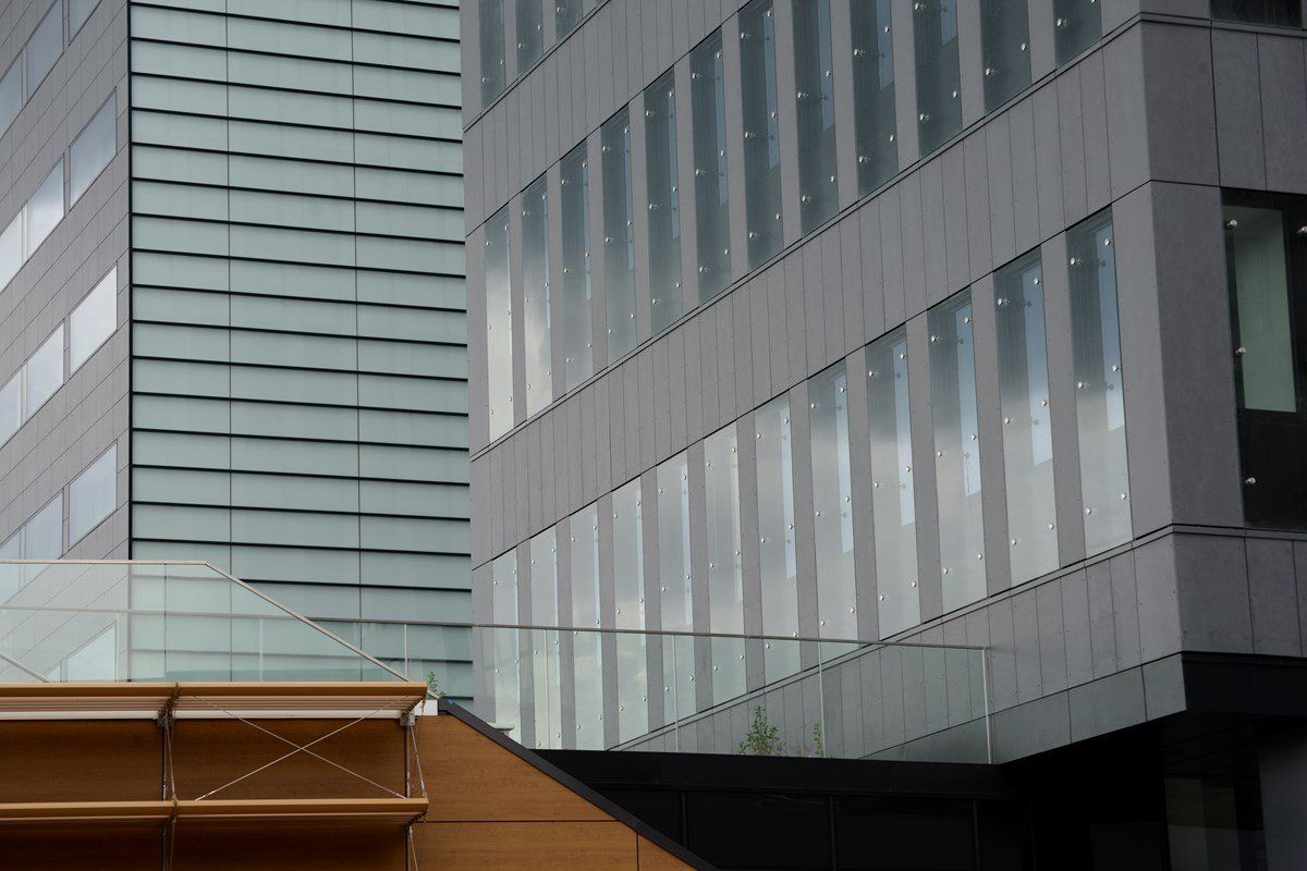 Modern buildings with reflective windows and gray facades.