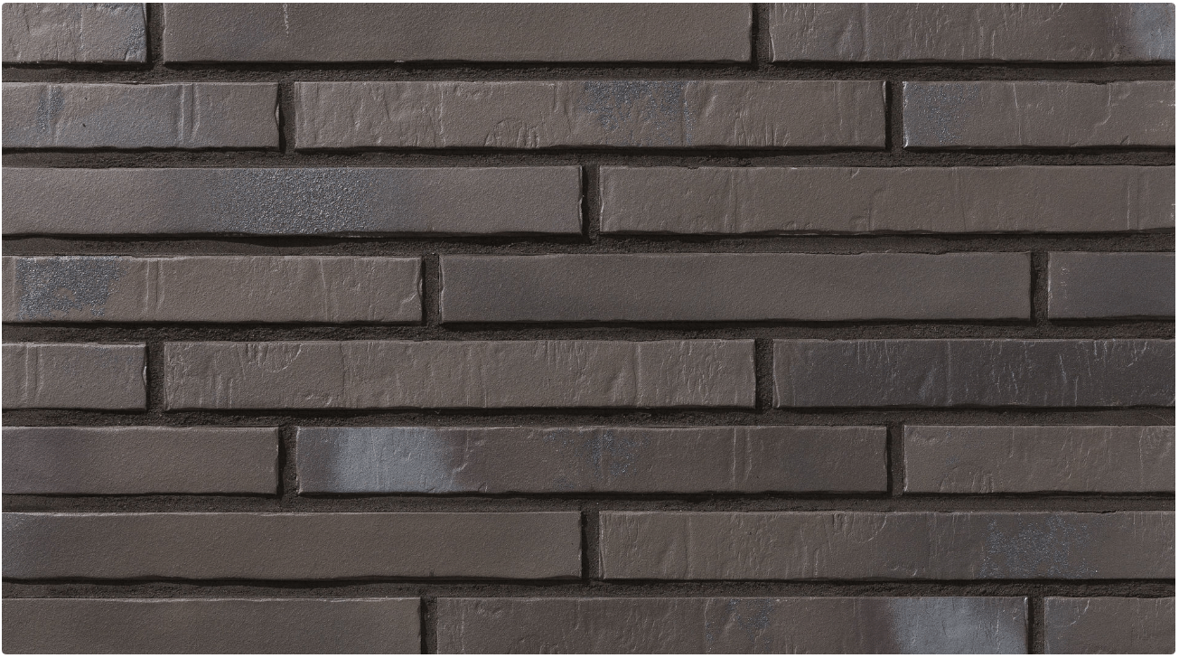Dark gray brick wall with rectangular bricks.