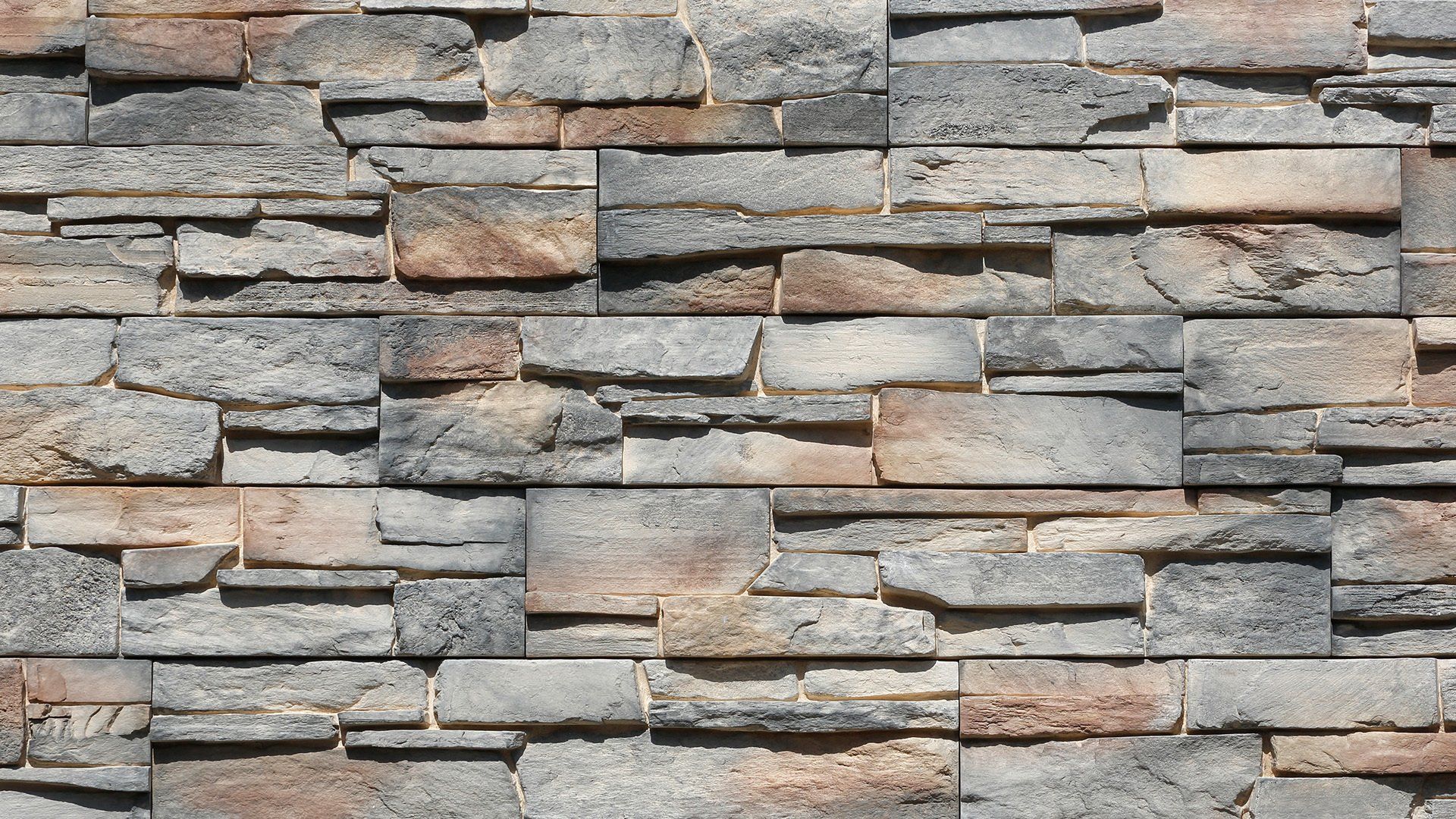 Gray and brown stone wall with rectangular, layered design.