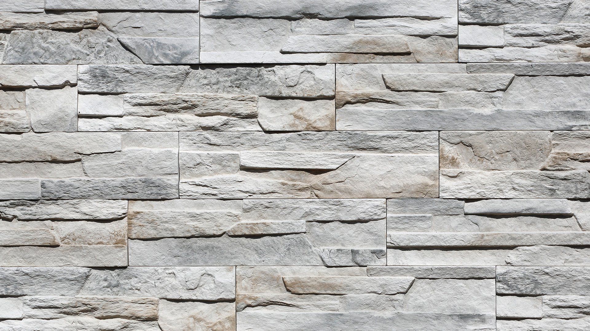 Textured gray and beige stacked stone wall.