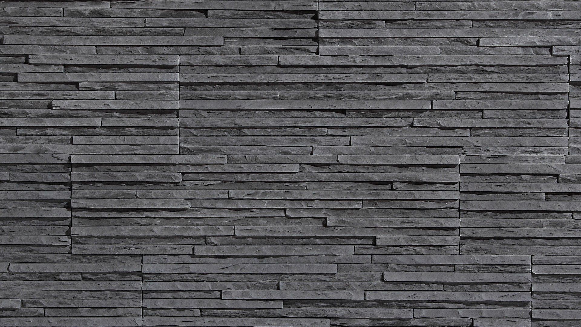 Dark gray stacked stone wall.