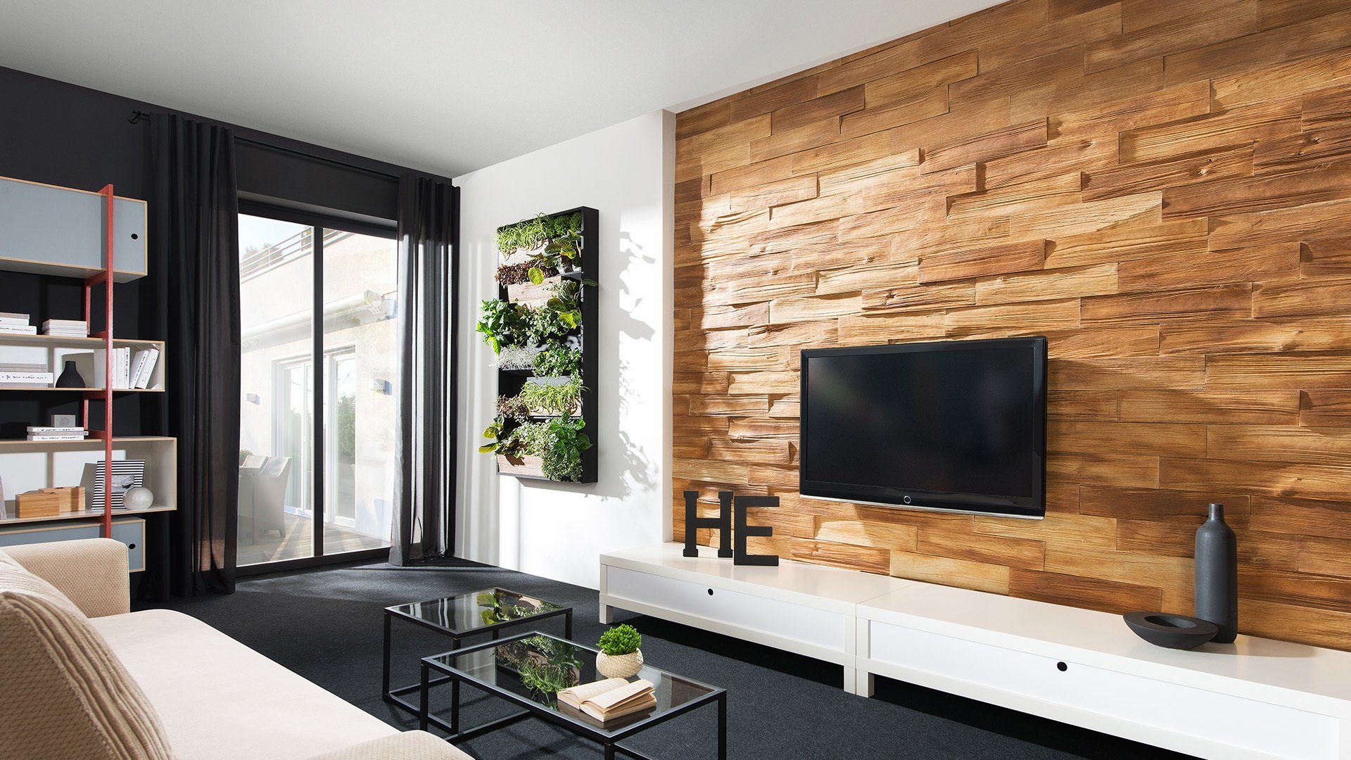 Modern living room with wood accent wall, TV, white console, and black furniture.