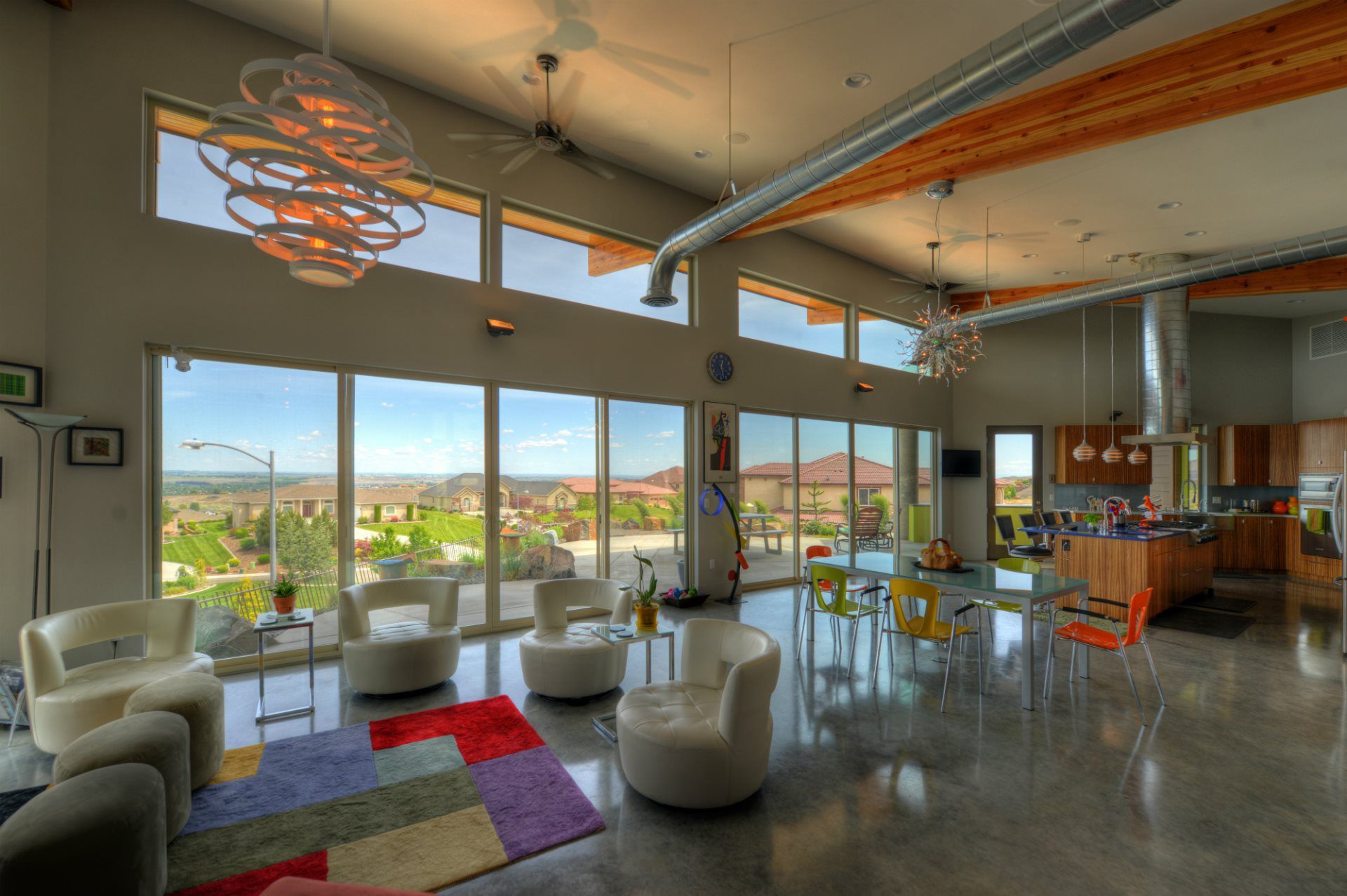 A living room with a lot of windows and chairs