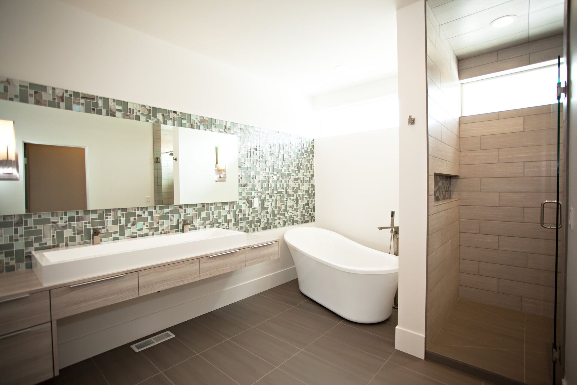 A bathroom with a tub , sink and shower.