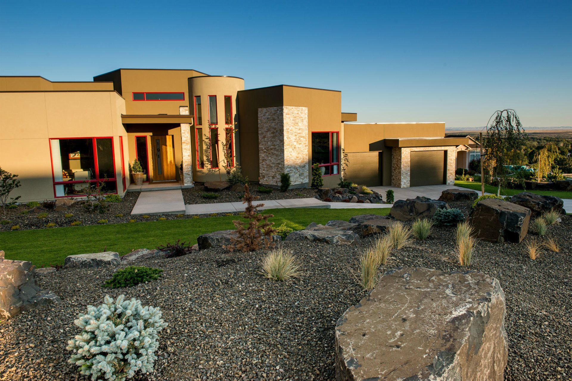A large house with a lot of rocks in front of it