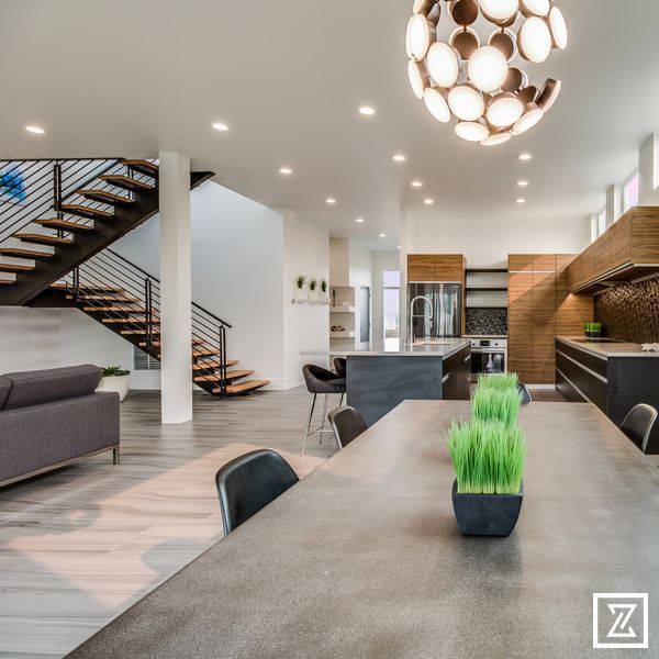A living room with a table and chairs and a staircase