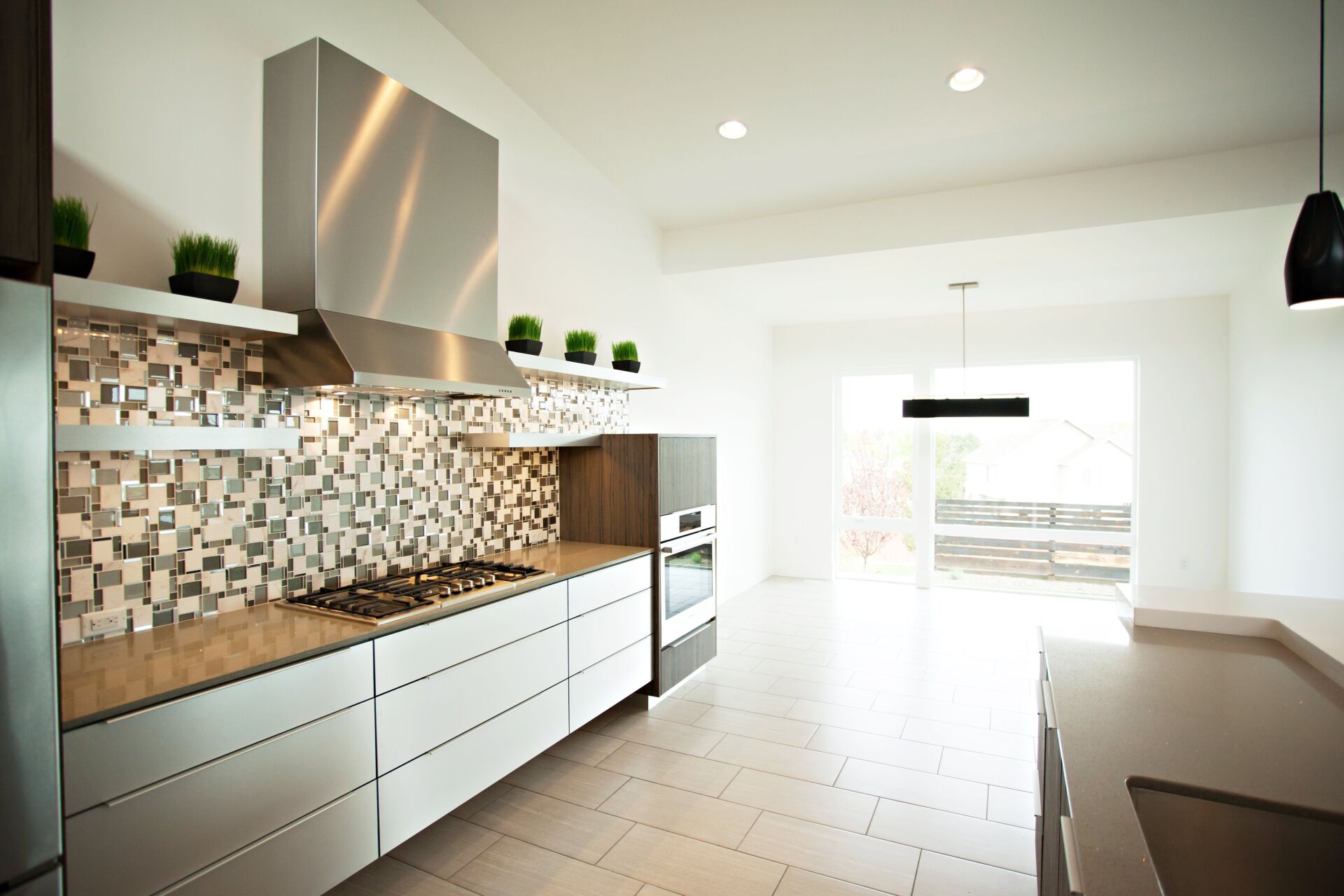 A kitchen with stainless steel appliances and white cabinets