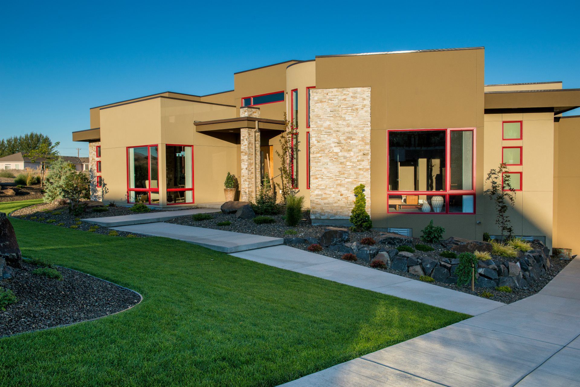 A large house with a concrete walkway leading to it