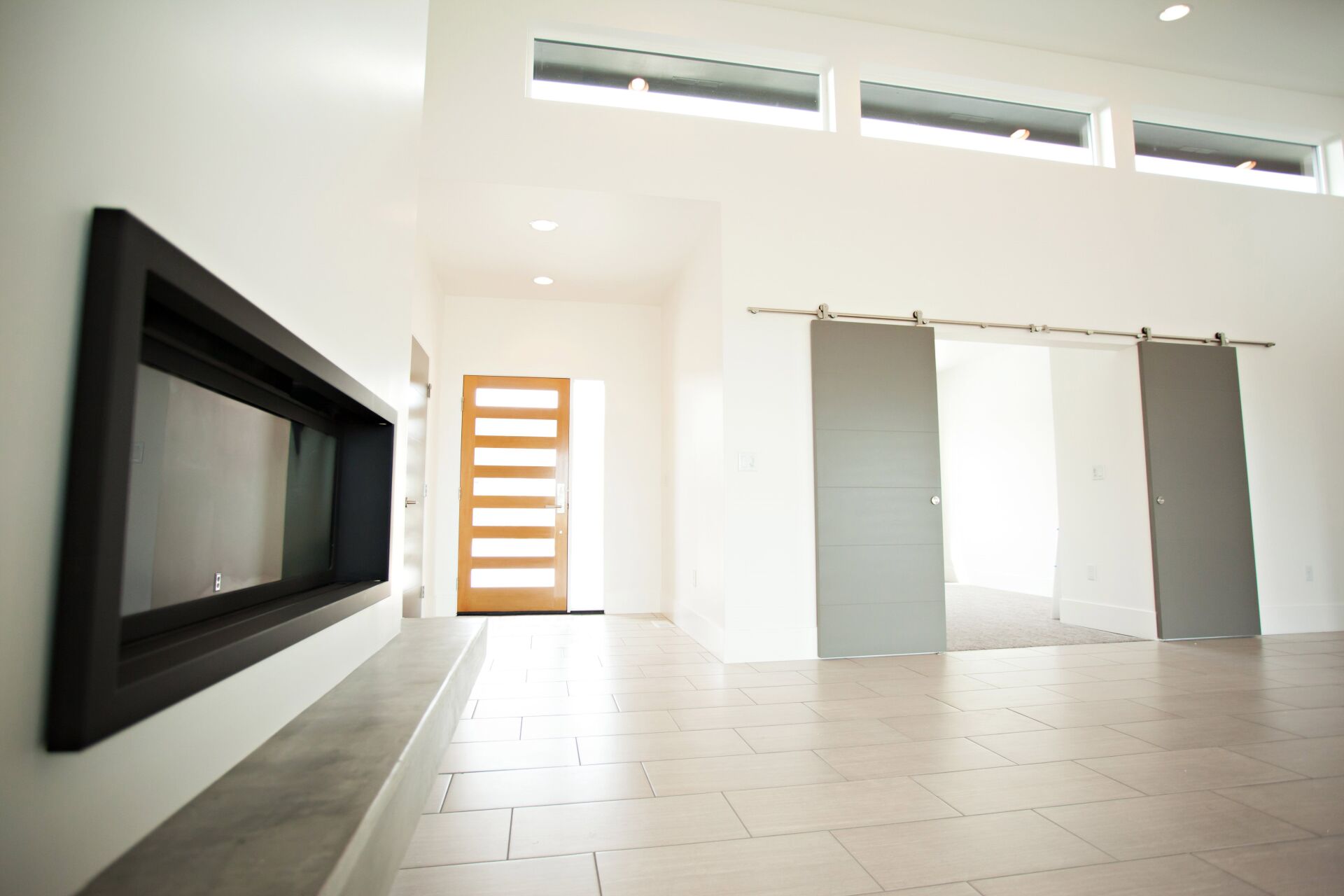 A living room with a fireplace and sliding doors