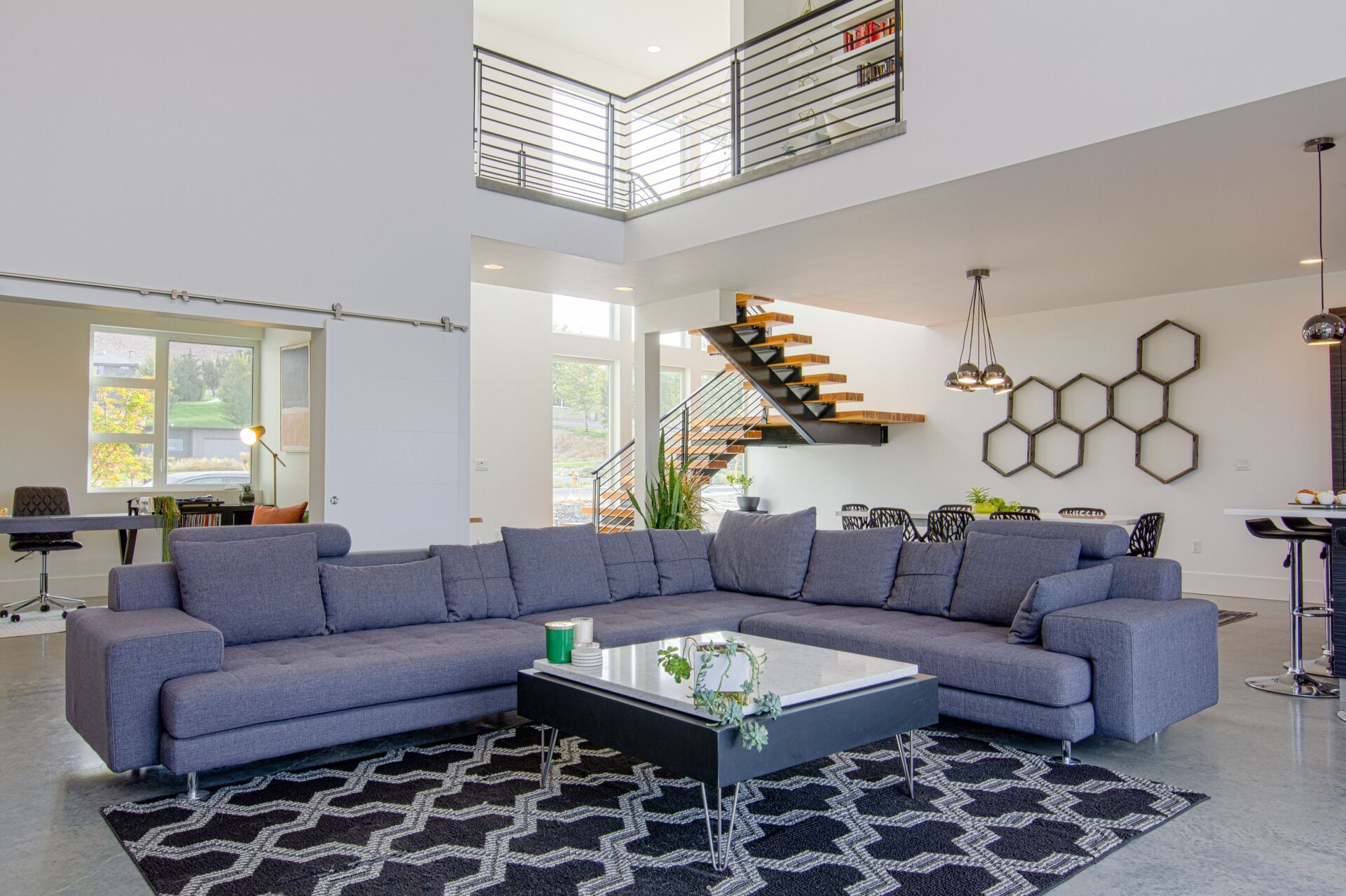 A living room with a large sectional couch and a coffee table.