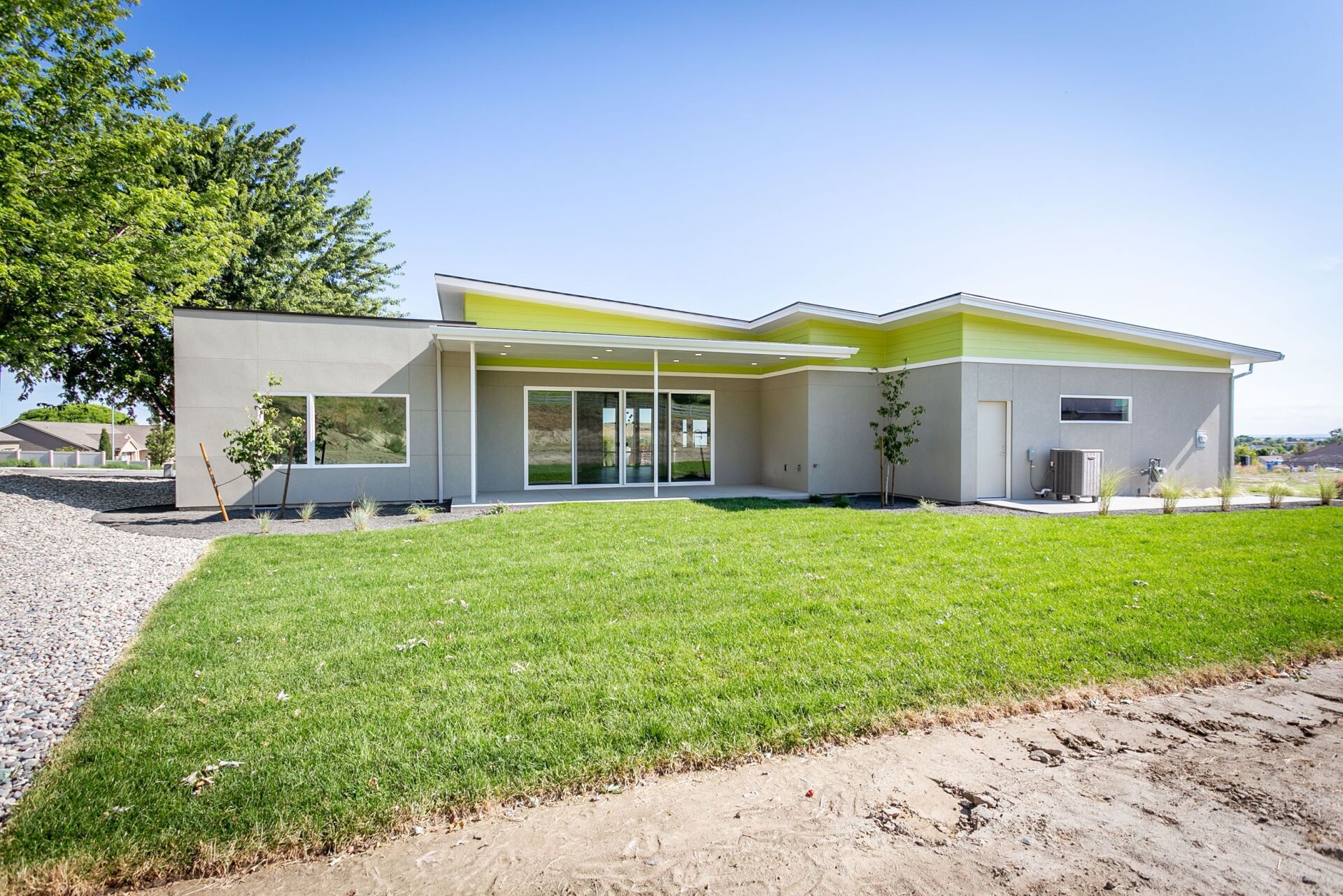 A house with a large lawn in front of it