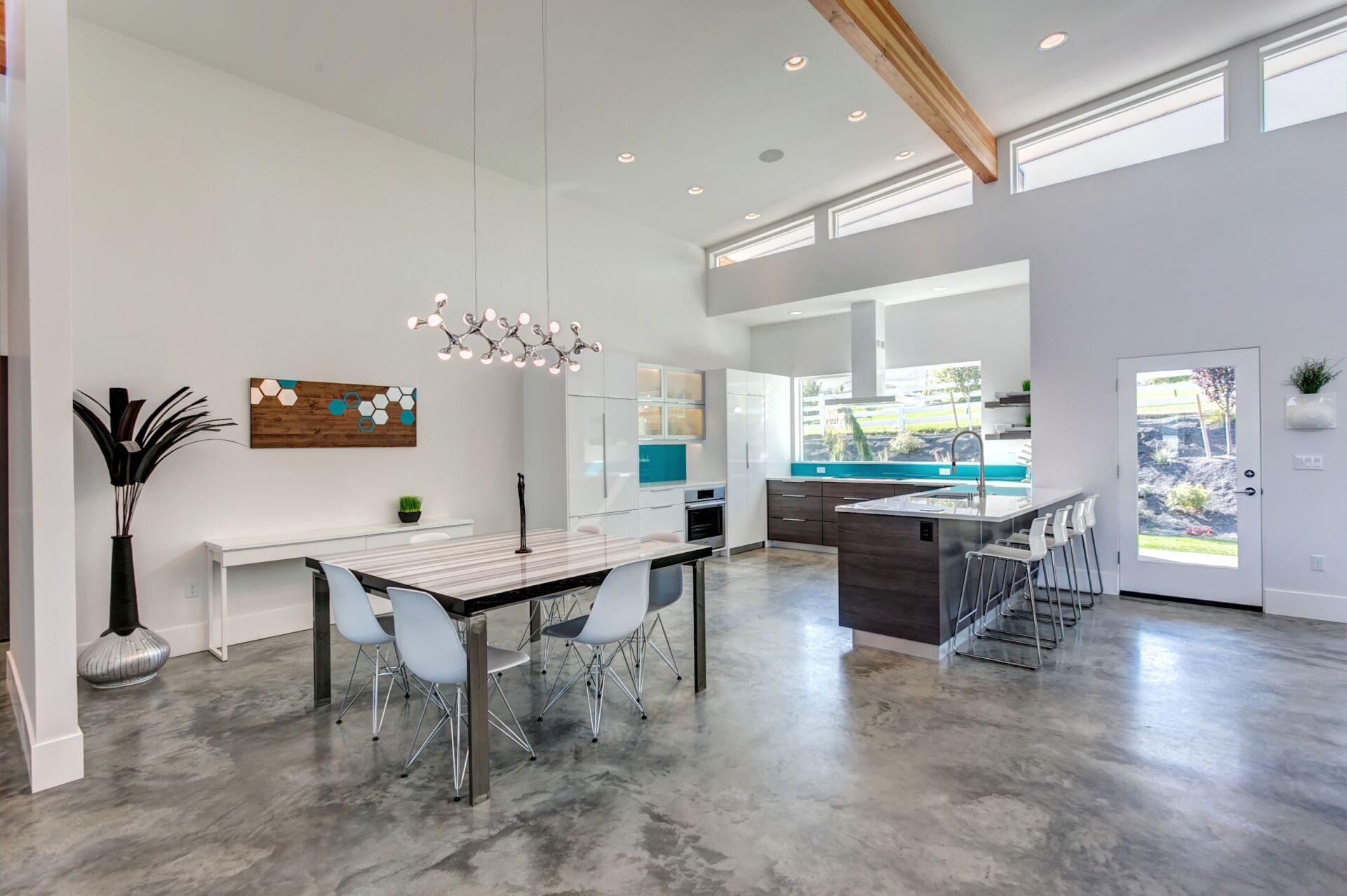 There is a dining table and chairs in the middle of the room.