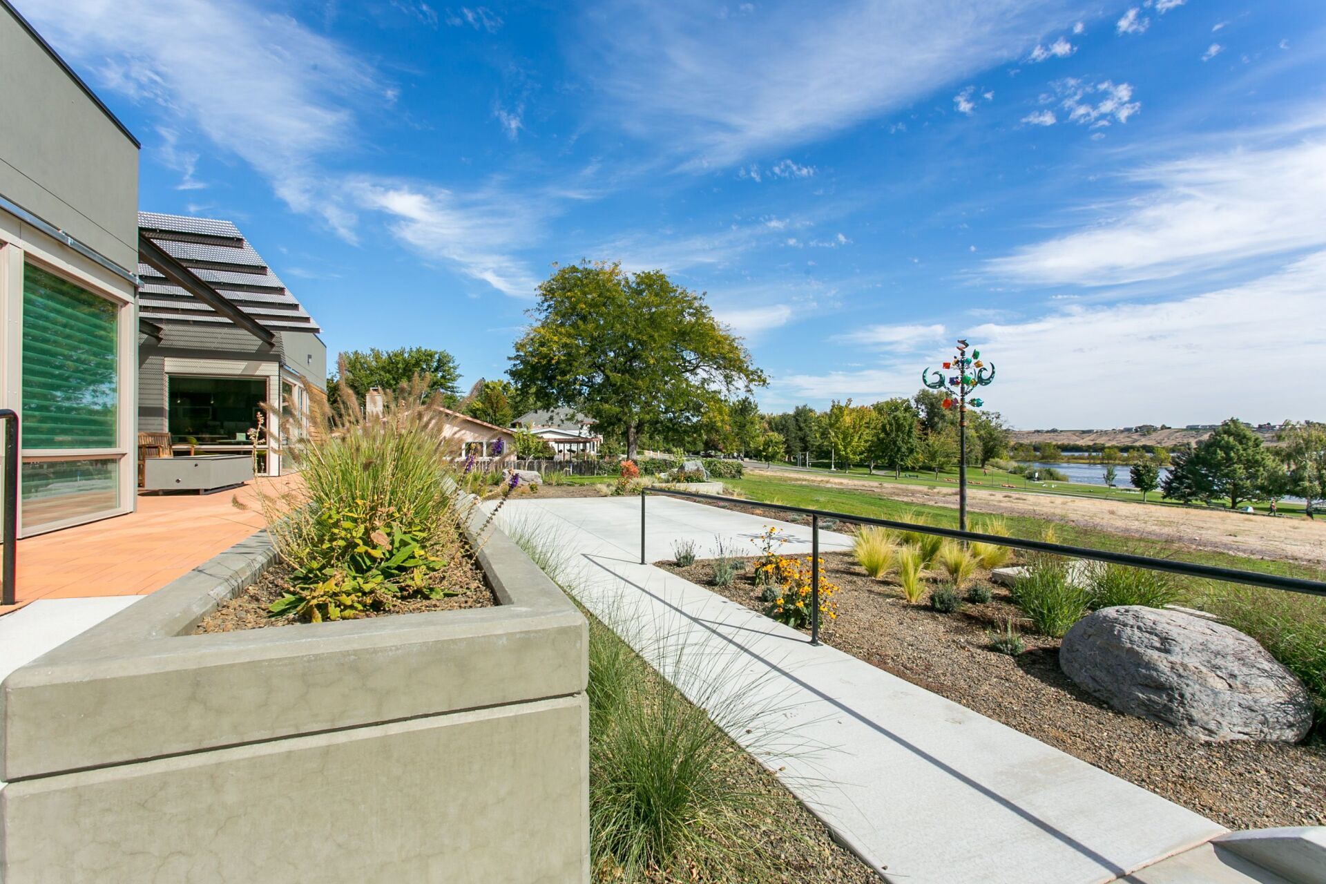 A walkway leading to a building with a river in the background.