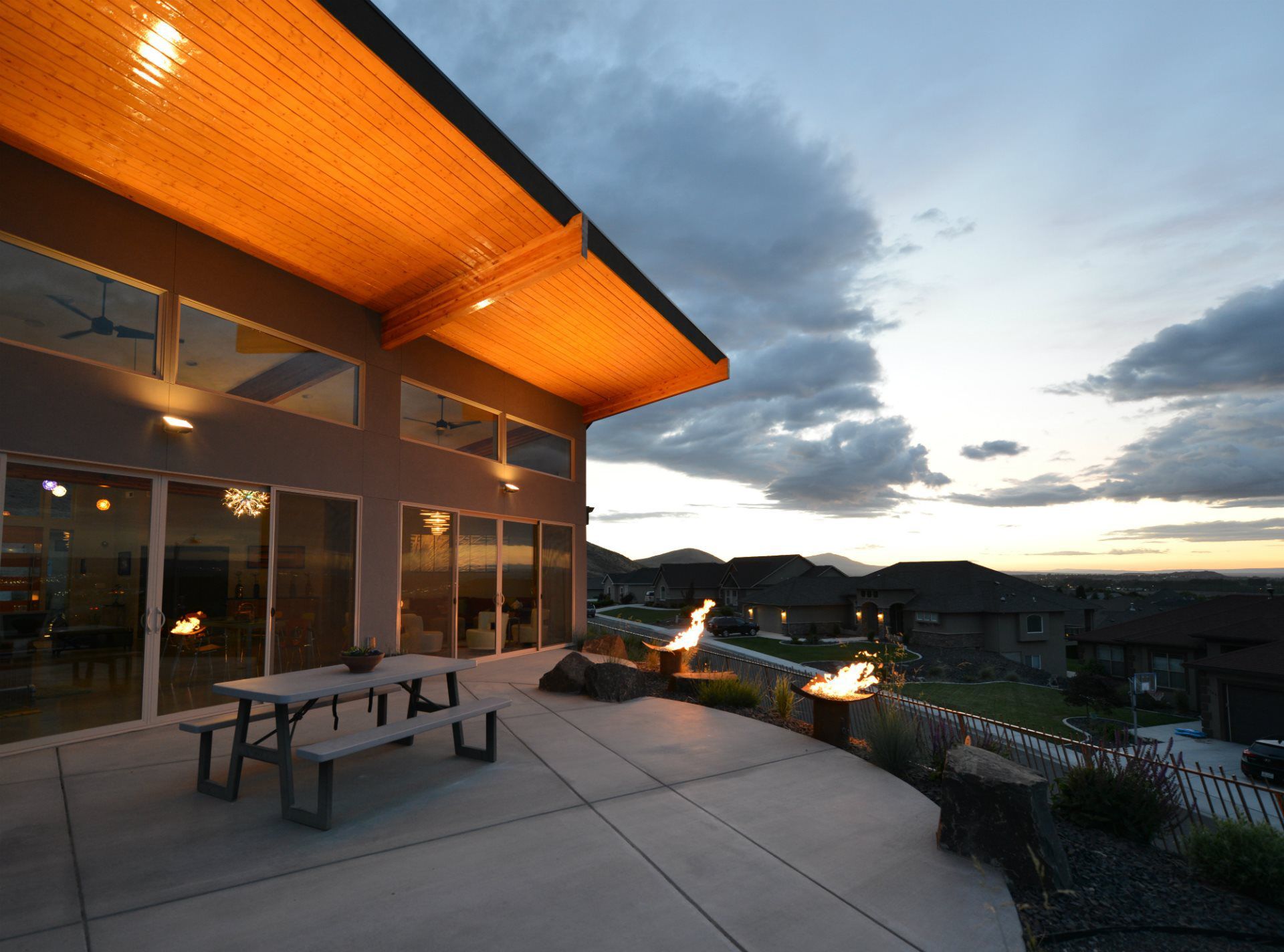 There is a picnic table on the patio of a house.