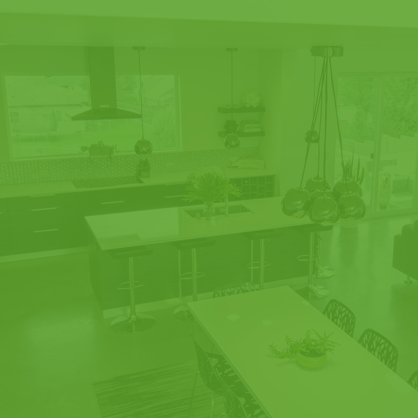 A kitchen with a large table and chairs and a green background.