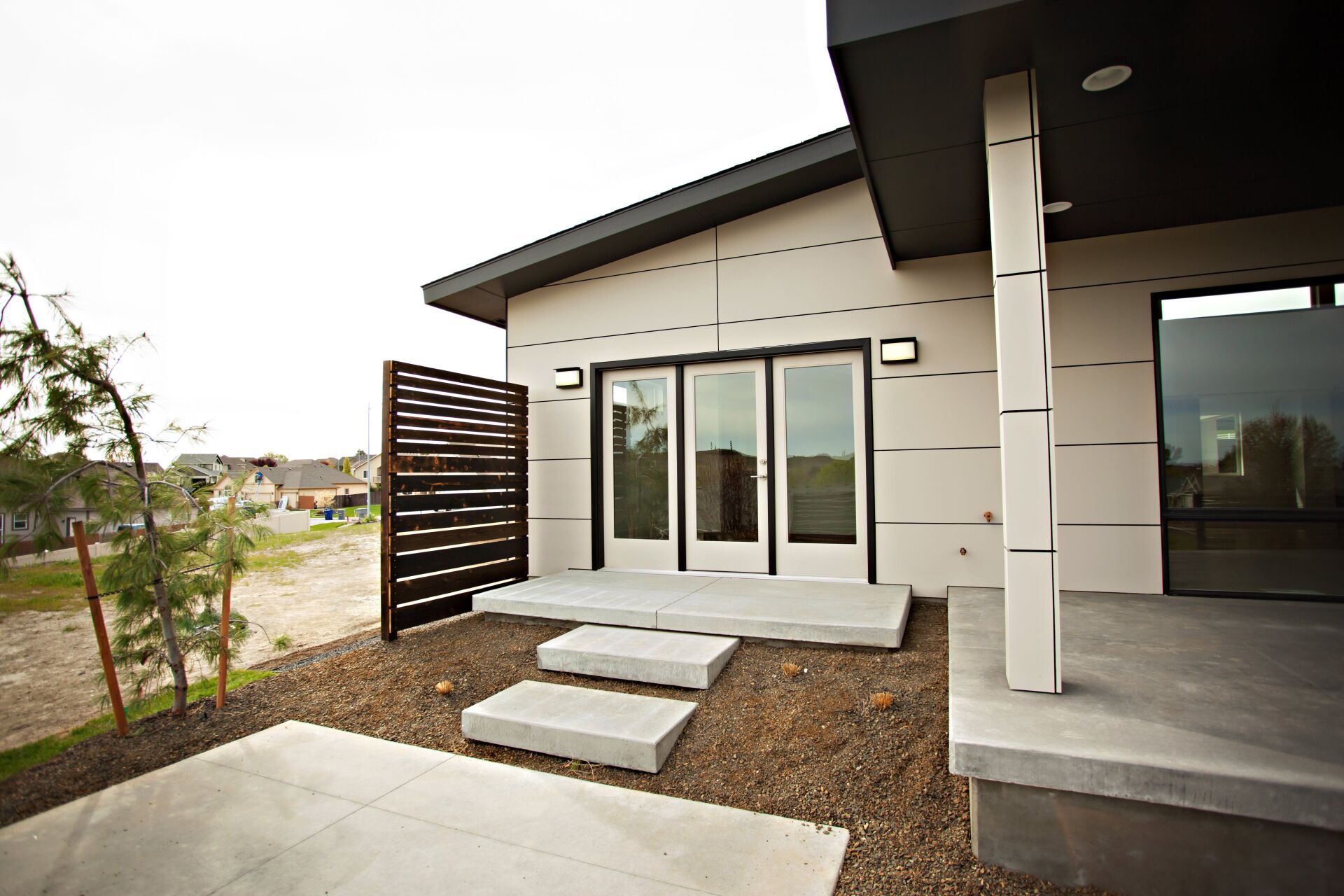 A modern house with a concrete porch and steps