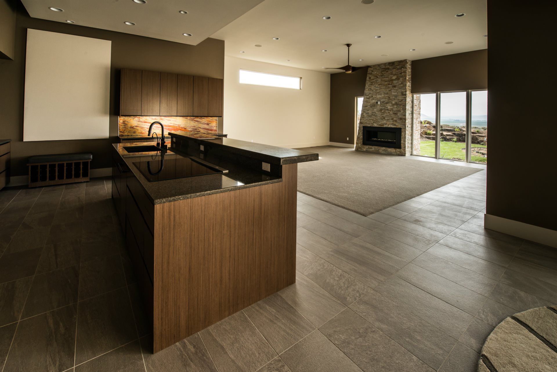 A kitchen with a large island and a fireplace