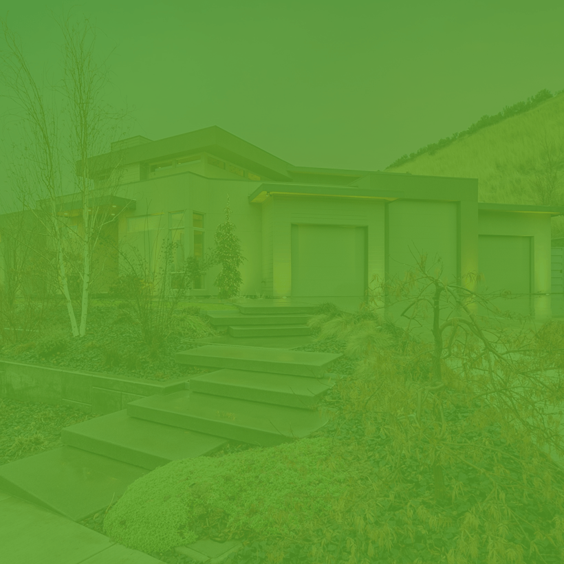 A green background with a house and stairs in the foreground.
