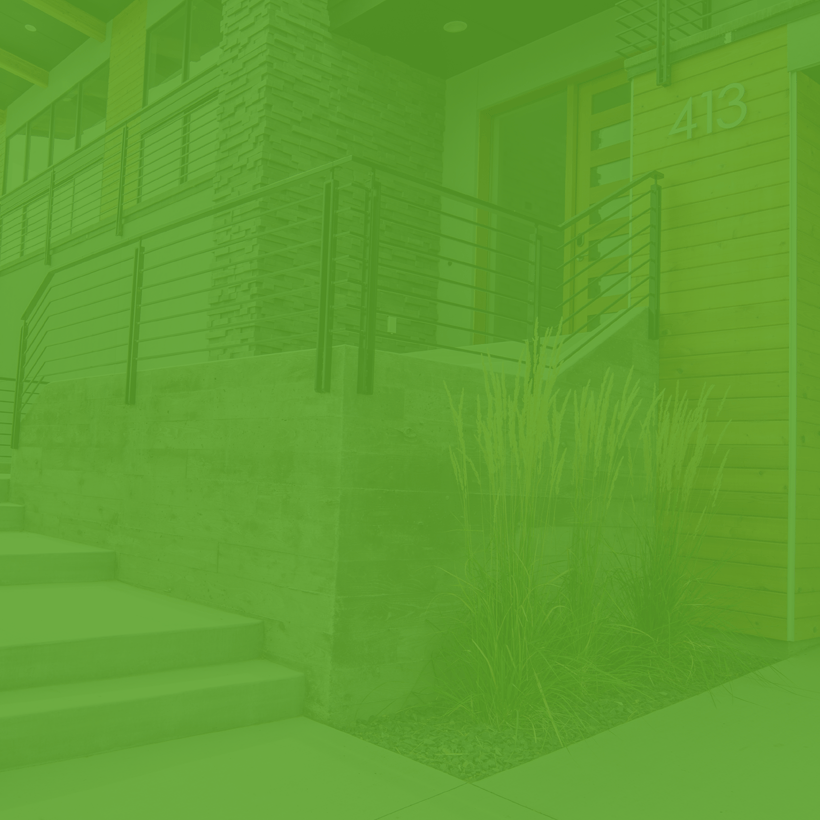 A green background of a house with stairs and a railing.