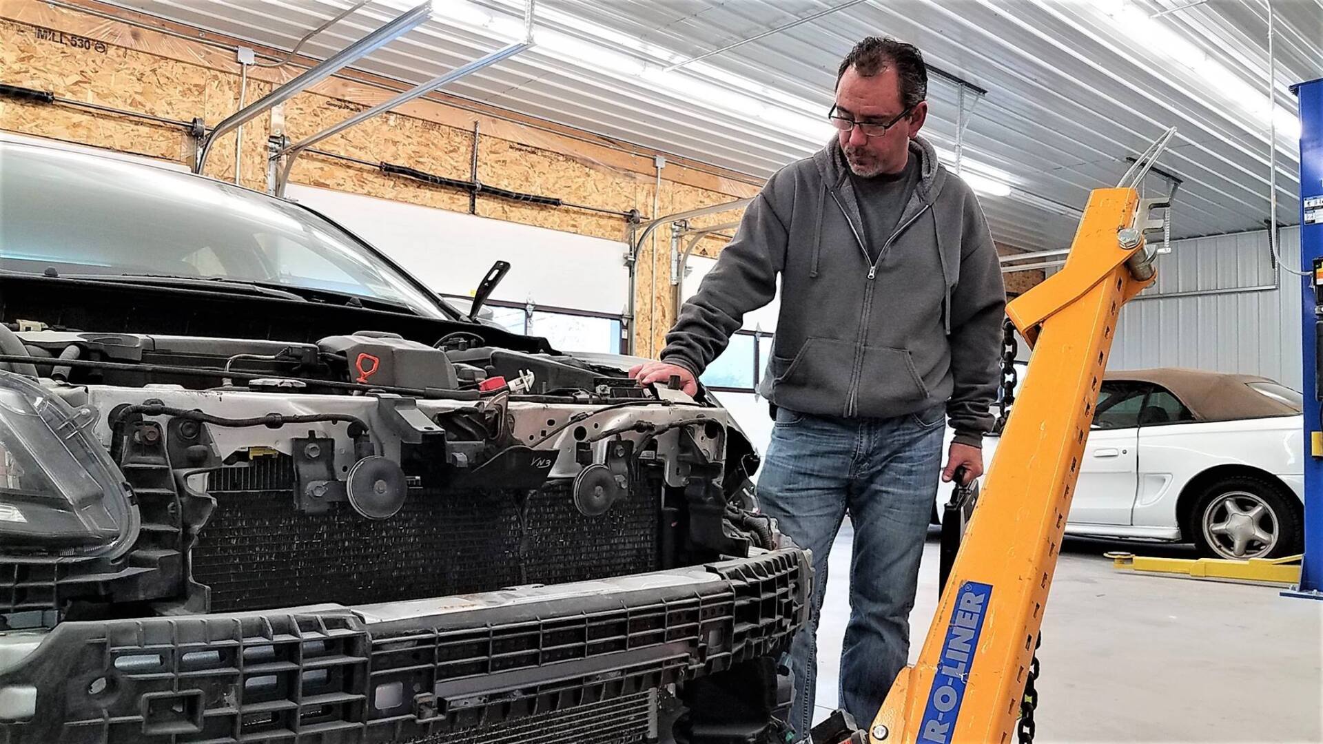 Collision Estimate Service Inspecting a vehicle during a collision repair job