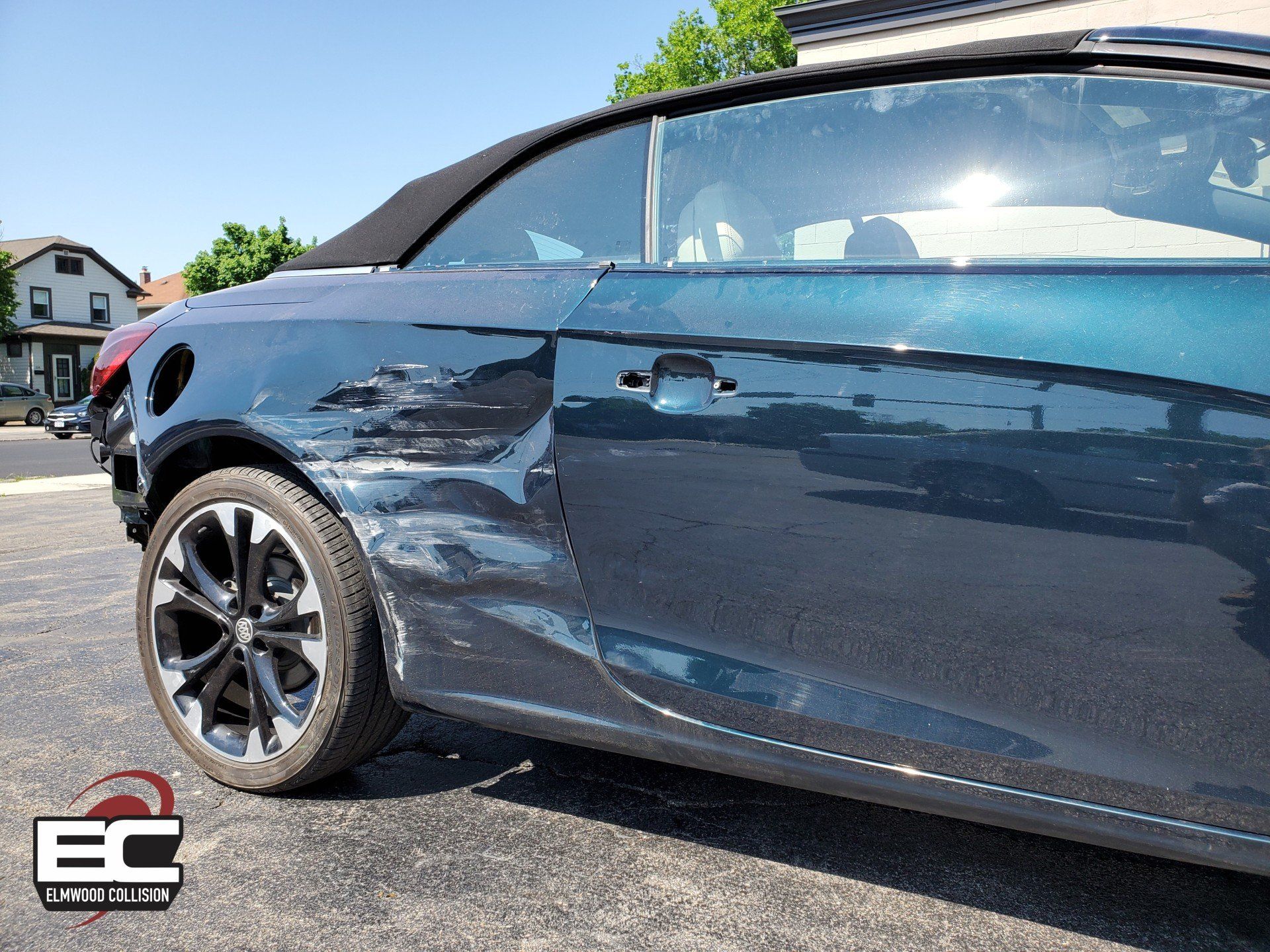 Elmwood Collision 2018 Buick Cascada with damaged quarter panel in parking lot at Elmwood Collision