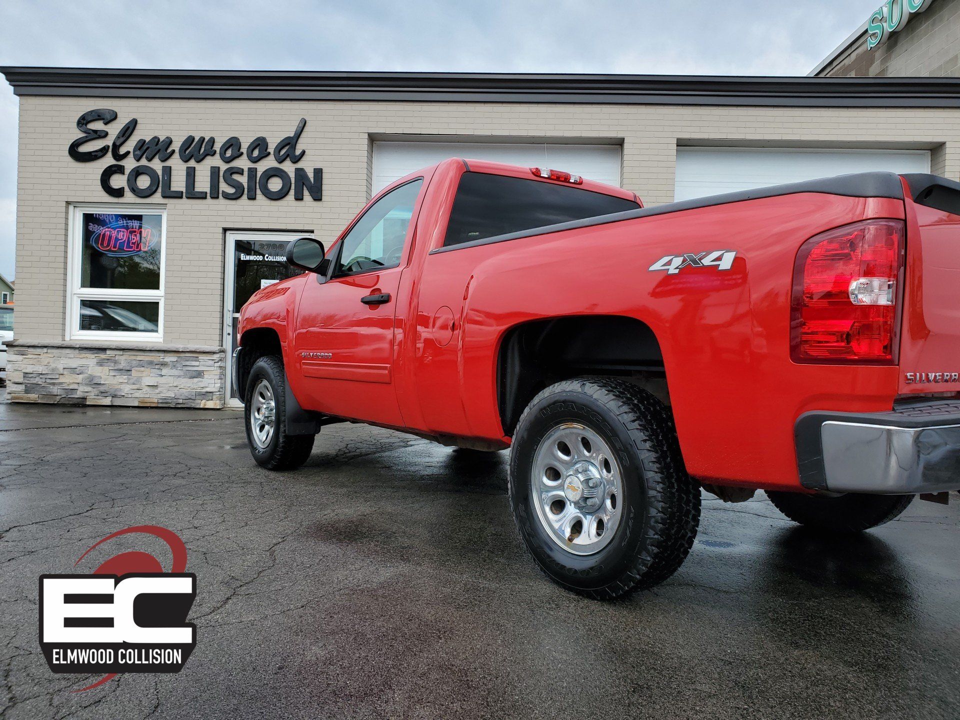 Chevy Silverado Besdside Repaired & Painted in parking lot at Elmwood Collision