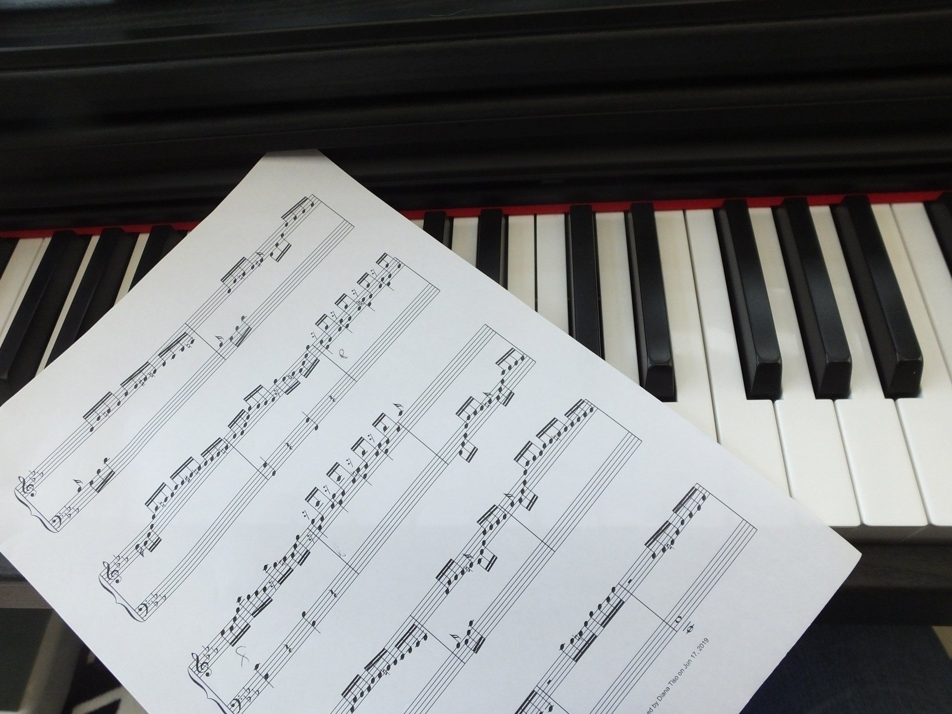 piano music score on piano keys