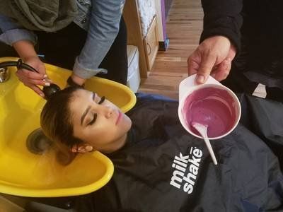 Perms — Stylist Washing Woman's Hair in Albuquerque, NM