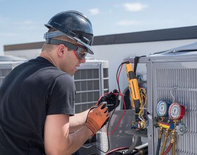 HVAC Technician Working on Condenser — Appalachia, VA — Better Air Heating and Cooling HVAC Technician Working on Condenser — Appalachia, VA — Better Air Heating and Cooling