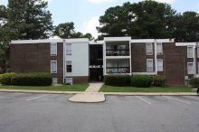 Cedar Point Apartments Three-story, red brick apartment building