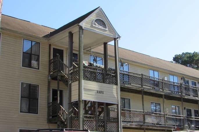 Three-story, beige apartment building