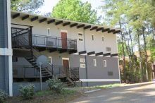 Courtyard Apartments (Crest Road) Two-story apartment building with red doors