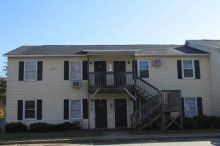 Glascock Apartments (Larson Drive) Small, two-story apartment building with yellow siding and blue shutters