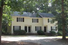Storm Court Townhouses Two-story townhouses with yellow siding and black shutters