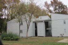 Woodridge Apartments (Buck Branch) Two-story apartment building with white siding exterior