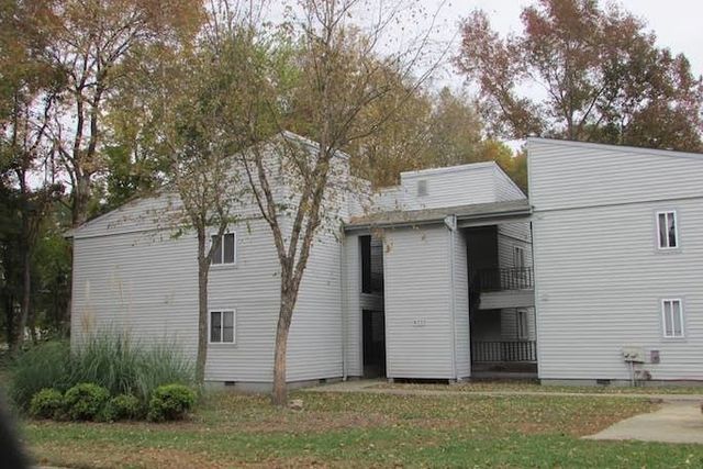Two-story apartment building with white siding exterior