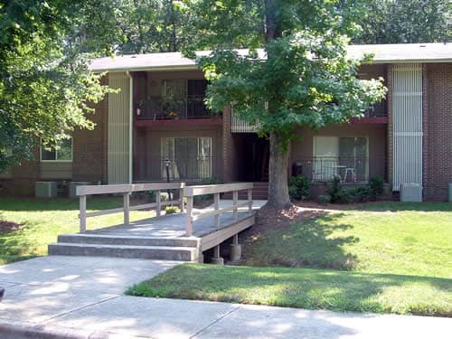 Two-story, brick apartment buildings surrounding by trees