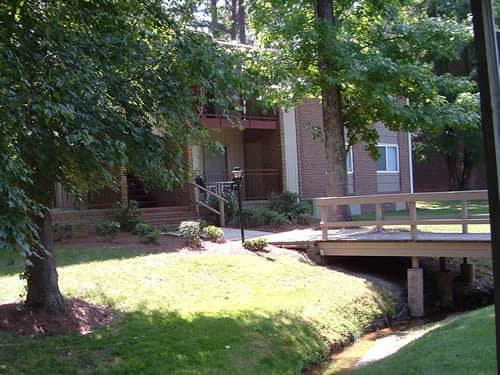 Two-story, brick apartment buildings surrounding by trees